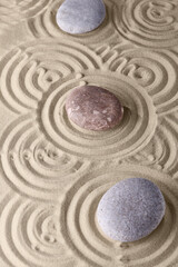 Circles on the sand and round stones in the rock garden, for relaxation and spiritual harmony