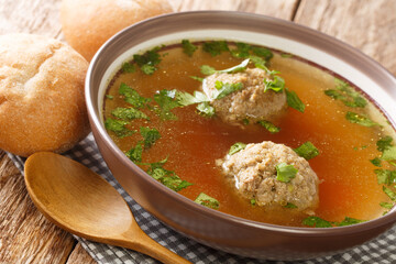 Homemade German broth with liver dumplings close-up in a plate. horizontal