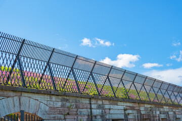 Iron fence on a fortress embankment