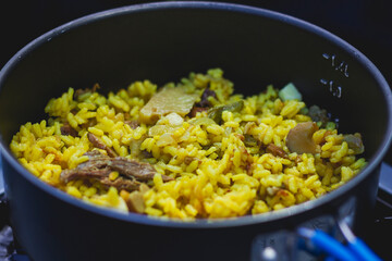 Cooking paella in camping gas in the mountains