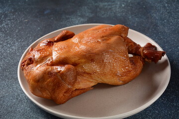 Roasted/baked whole chicken with spices, orange and herbs. Christmas food concept.