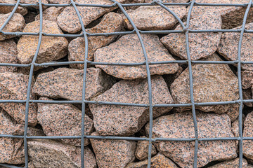 The rock behind the steel mesh design, protect