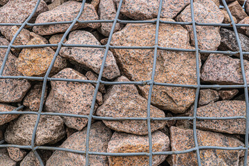 The rock behind the steel mesh design, protect