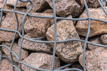 The rock behind the steel mesh design, protect