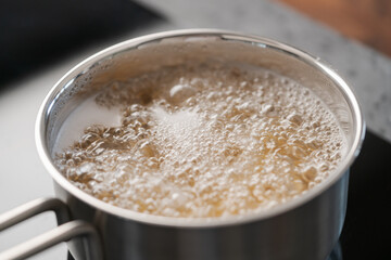 Boiling pasta in a saucepan on home kitchen