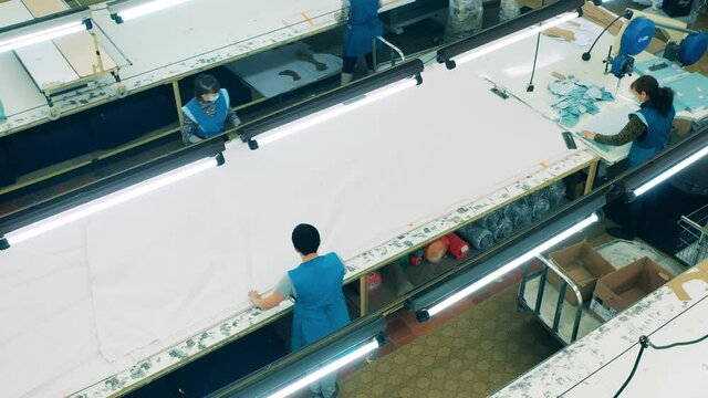 Garment factory unit with employees working with cloth