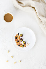 Homemade chocolates in a plate with a cup of coffee. Sugar, gluten and lactose free.