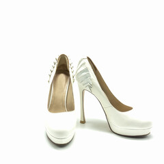 Women's white shoes with high heels and platform. Made of genuine leather. Decorated with pleats at the back. Isolated over white background.