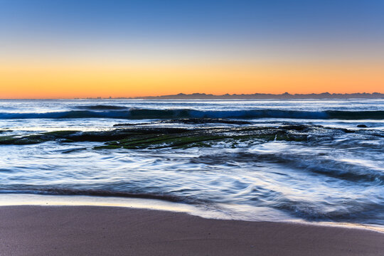 Clear skies and small waves, dawn at the beach