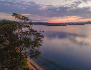 Sunrise waterscape with clouds and reflections