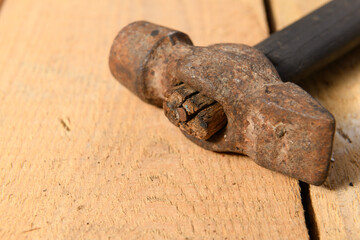 Old vintage hammer closeup on a wooden background, household hand tools