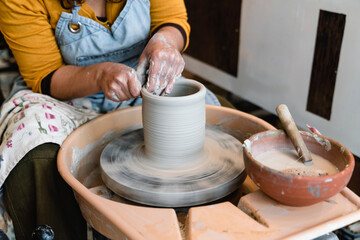 Potter making ceramic pot on the pottery wheel