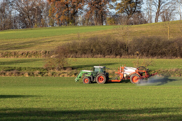 Landwirt mit Traktor sprüht Pflanzenschutzmittel