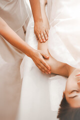 Close-up view masseur hands doing hand shoulder massage. Selective focus