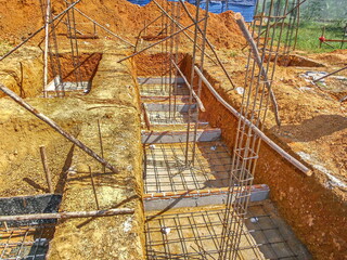 Construction work.Placing concrete foundations. Pouring concrete. Precast concrete products.