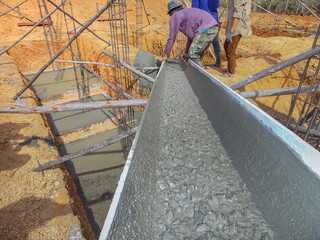 Construction work.Placing concrete foundations. Pouring concrete. Precast concrete products.