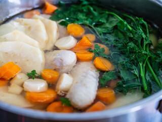 Broth - boiling chicken soup in pot
