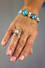 Detail of ring put on the hand of an older woman with wrinkles