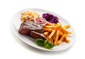 Grilled beef steak with french fries and vegetable salads  served on white background 