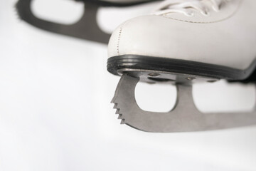 Obraz premium White figure skates with silver blades and prong close-up on a white background