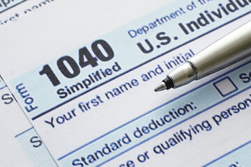 Obraz premium Annual tax reporting. Tax form on the table. Financial statements for signature.