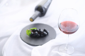 Glass with grape red semi-dry wine. Valentine's day concept background. Gift for the holiday. Sweet sparkling wine.
