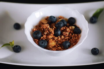 A healthy breakfast cereal with milk and fruit. Oat and corn flakes with chocolate and yogurt. The concept of healthy and vegetarian food.