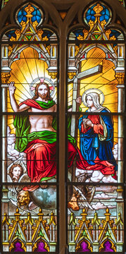 VIENNA, AUSTIRA - OCTOBER 22, 2020:  The Jesus with the cross in his glory with the Mary on the stained glass in the church Laurentiuskirche by workrooms from Czech and Austria (end of 19. cent.).