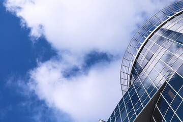 Architectural detail of the facade with multiple reflections of other buildings and the sun. Modern building. Architecture background