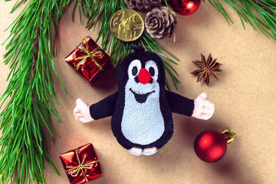 Czech Republic, Prague-2020 November: Czech plush mole among Christmas decorations small gifts and Christmas tree branches.