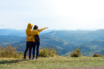 A young couple admiring the beautiful mountain views.