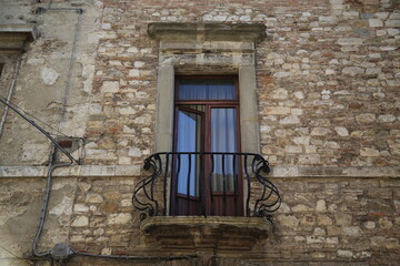 Fototapeta na wymiar Ancient window in a house of the medieval city of Todi
