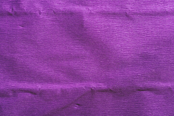 Purple crumpled paper background. Corrugated paper texture.
