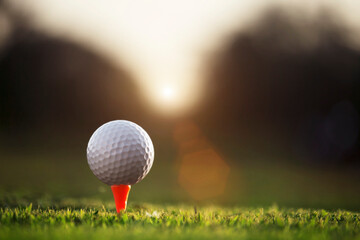 golf ball on tee in a beautiful golf course with morning sunshine