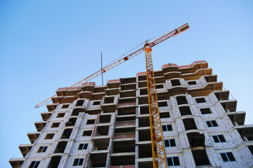 Construction site background. Big tower crane near building. Industrial background.