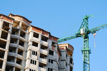 Fototapeta na wymiar Construction site background. Crane near building. Industrial background.