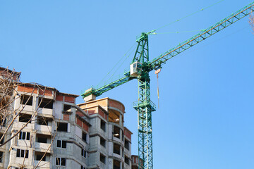Fototapeta na wymiar Construction site. Crane near building. Industrial background.