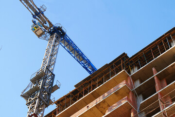 Fototapeta na wymiar Crane near building. Construction site background.