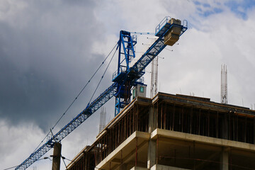 Crane near building. Construction site background. Industrial background.