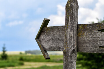 Old wooden weathered pointer. Selective focus.
