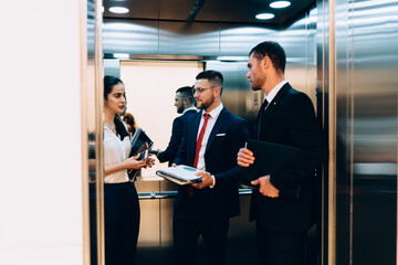 Cheerful group of coworkers in elevator © BullRun