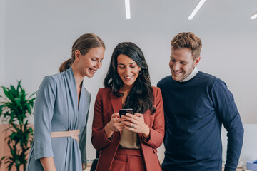 Group of Businesspeople Looking at Cell Phone