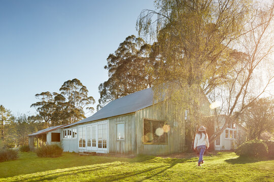 Woman walking towards a farmhouse