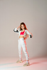 Teenage female dancing hip-hop in studio, casual clothes