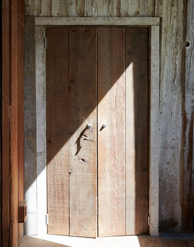 Old wooden doors on a rustic farmhouse