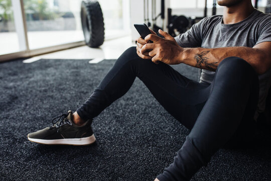 Sportsman Typing on his Cell Phone