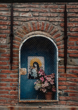 Holy picture and votive flower in a tabernacle close up