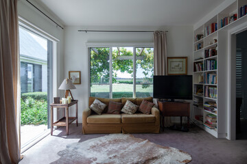 Comfy sofa setting in library room of country homestead