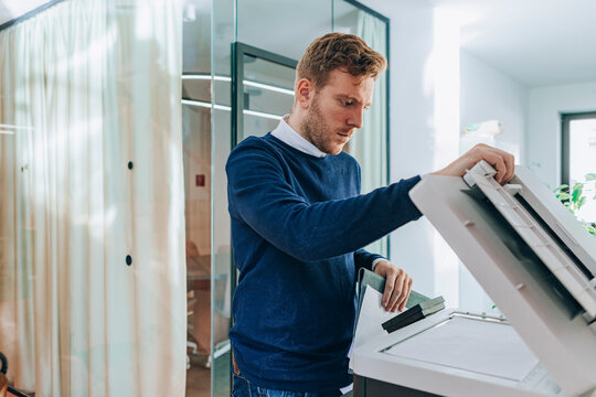 Young Businessman Using Copier