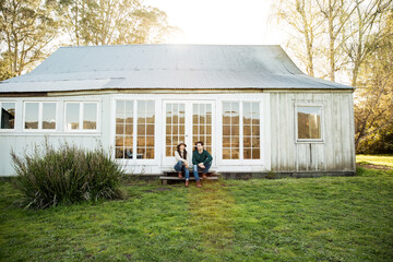 Couple sitting on farmhouse steps